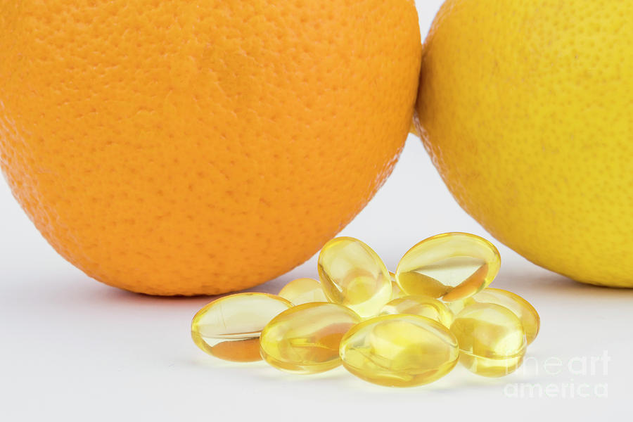 Pills Next To Oranges Photograph by Digicomphoto/science Photo Library