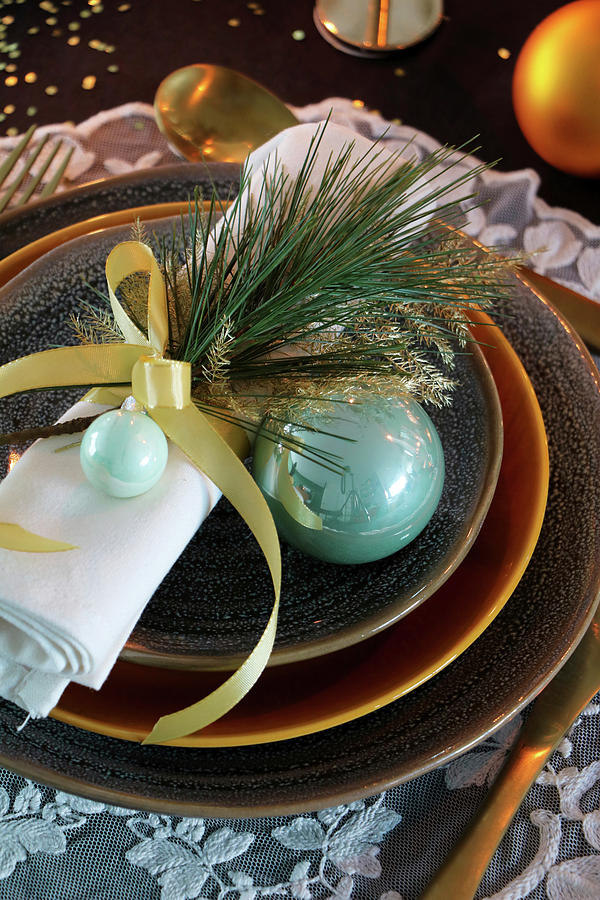 Pine Twig And Turquoise Christmas-tree Bauble On Napkin Photograph by Marij Hessel