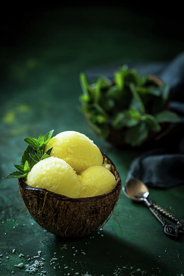 Pineapple Sorbet With Mint Served In A Coconut Shell Photograph by Anna Lukasiewicz