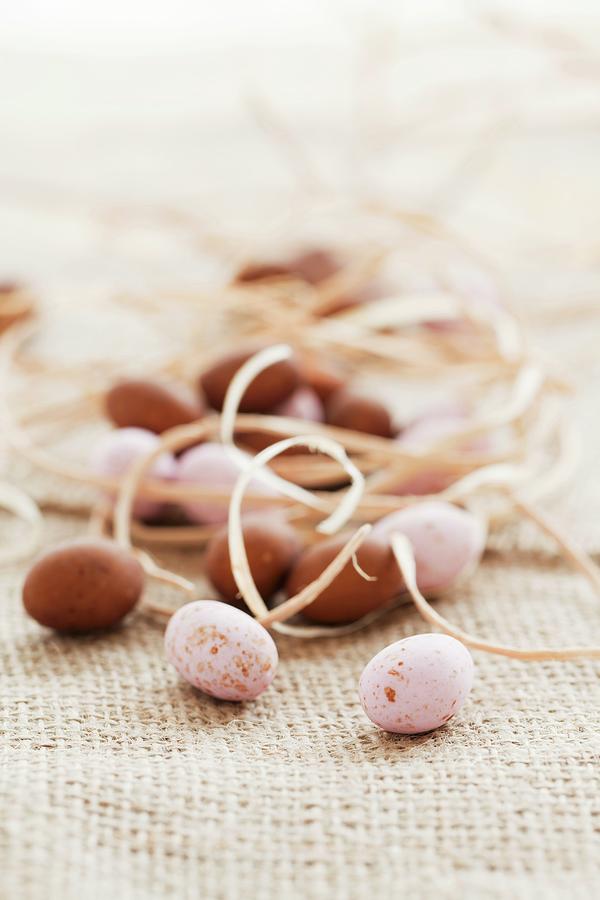 Pink And Brown Mini Chocolate Eggs With Straw On A Piece Of Jute Photograph by Jane Saunders