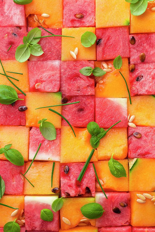 Pink And Yellow Diced Melon With Melon Pips And Basil Leaves Photograph by Great Stock!
