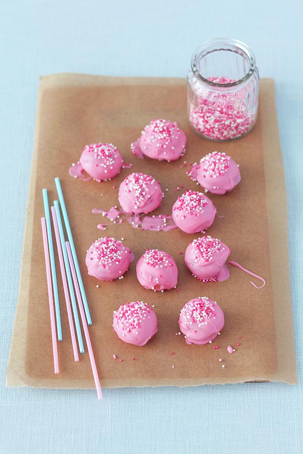 Pink Cake Pops On A Piece Of Baking Paper Photograph by Rua Castilho