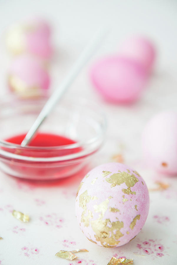 Pink Eggs With Gold Leaf And Bowl Of Dye Photograph by Ruud Pos