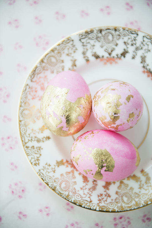 Pink Eggs With Gold Leaf On Vintage-style Plate Photograph by Ruud Pos