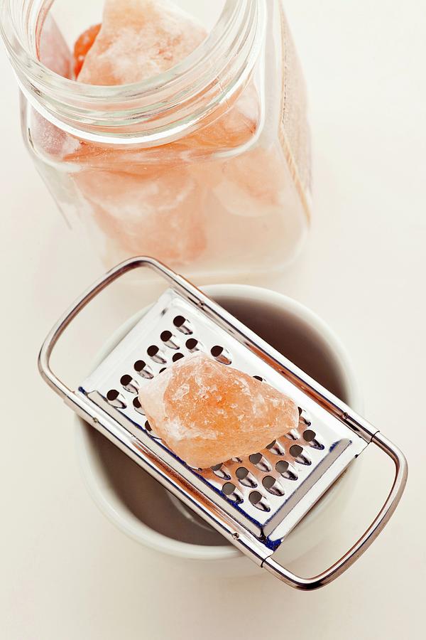 Pink Himalayan Salt With A Grater Photograph by William Boch