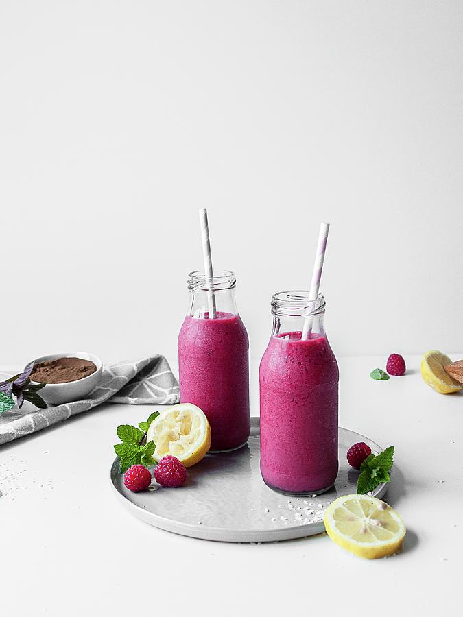 Pink Liquorice And Raspberry Smoothie Served In Glass Bottles Photograph by Freiknuspern