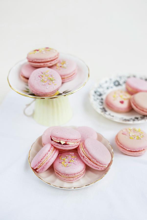 Pink Macaroons Filled With Raspberry Jam And Clotted Cream Photograph by Lucy Parissi