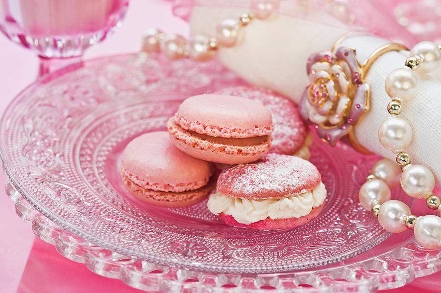 Pink Macaroons On A Glass Plate With A Pearl Necklace And A Napkin Photograph by Linda Burgess