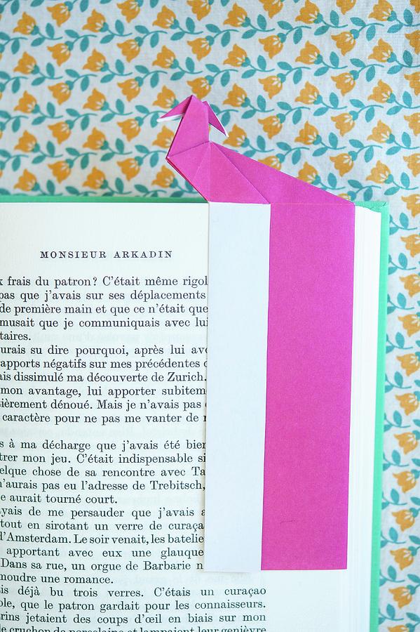Pink Origami Bookmark On Page Of Open Book Photograph by Studio27neun