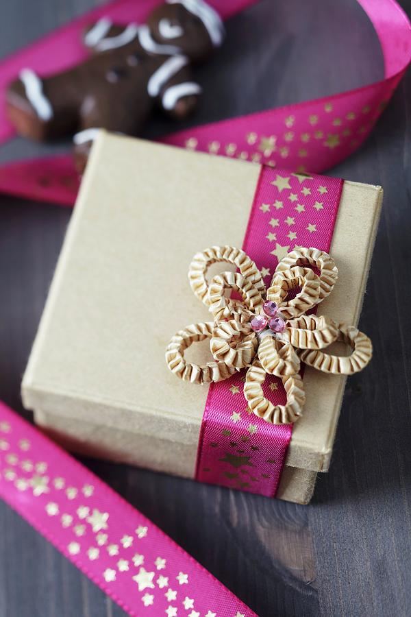Pink Ribbon With Pattern Of Stars And Cardboard Bow On Gift Box Photograph by Franziska Taube