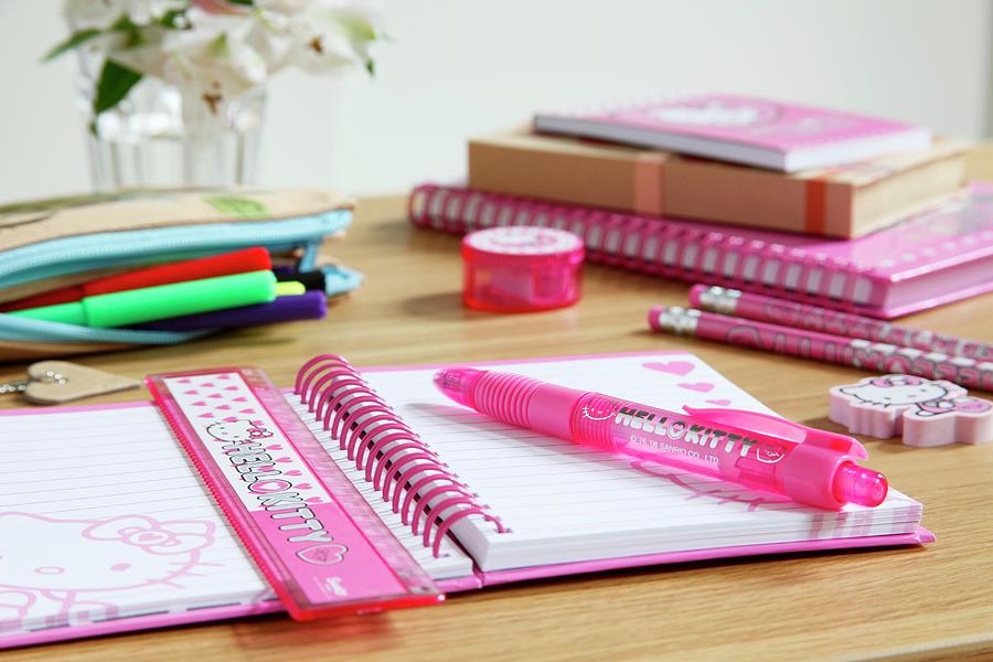 Pink Writing Materials On Childs Desk Photograph by Simon Scarboro