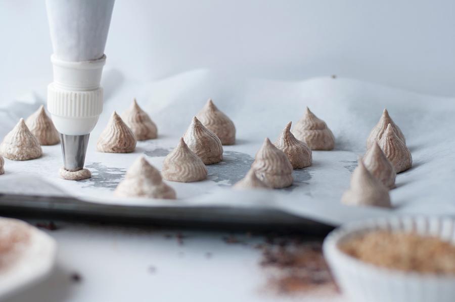 Piping Chocolate Meringues Onto A Tray Photograph by Healthylauracom