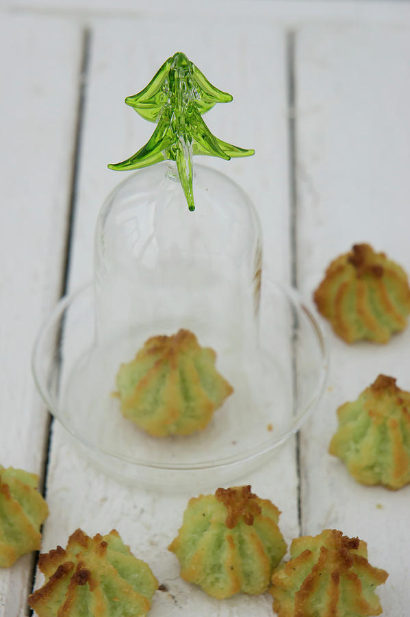 Pistachio And Coconut Macaroons With One Under A Glass Cloche Photograph by Martina Schindler