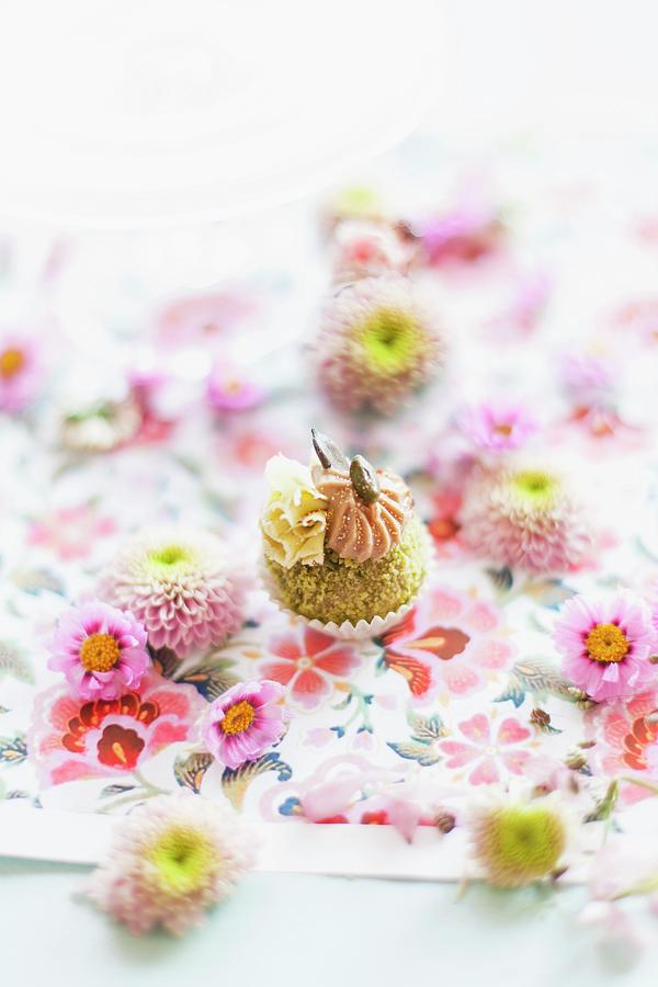 Pistachio Confectionery Decorated With Flowers On A Floral Tablecloth Photograph by Anneliese Kompatscher
