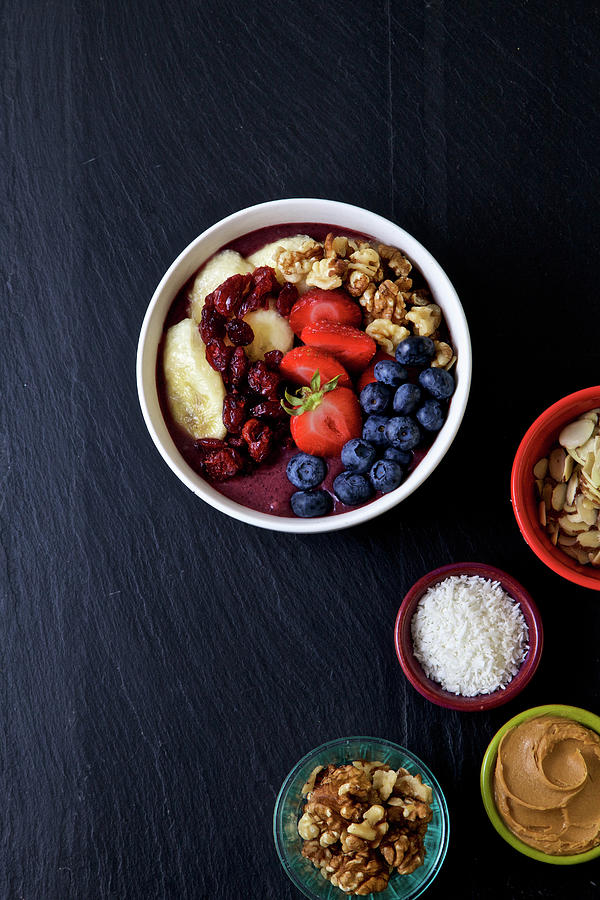 Pitaya Bowl With Bananas, Blueberries Almonds, Strawberries, Coconuts Flakes And Cranberries, Peanut Butter Photograph by Andre Baranowski