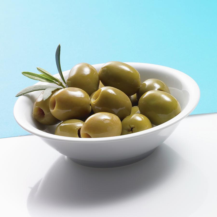 Pitted Green Olives In A White Bowl Photograph by Brigitte Wegner