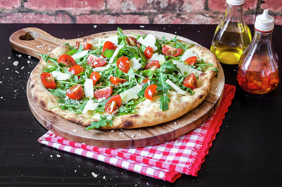 Pizza Made With A Sourdough Base, Fresh Rocket Leaves, Cherry Tomatoes And Parmigiano Cheese On A Wooden Board Photograph by Giulia Verdinelli Photography