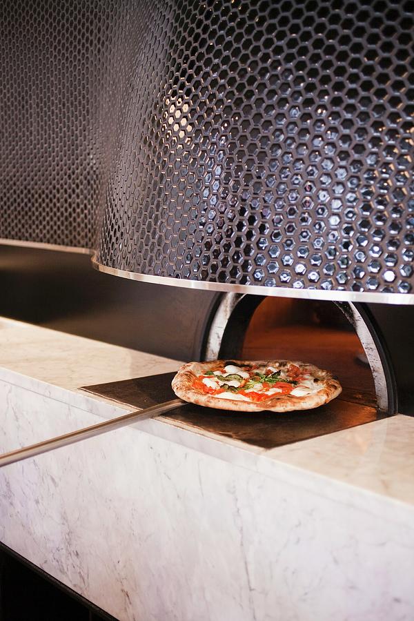 Pizza On A Pizza Paddle Coming Out Of A Wood Burning Oven Photograph by Jennifer Martine