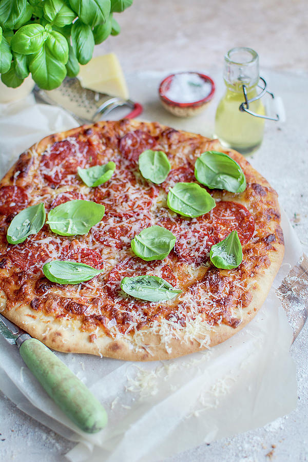 Pizza With Pepperoni, Cheese And Basil Photograph by Olimpia Davies