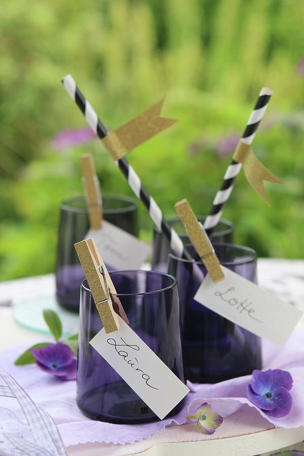 Place Cards Clipped To Purple Glasses With Gold Clothes Pegs And Drinking Straws With Washi-tape Flags Photograph by Regina Hippel