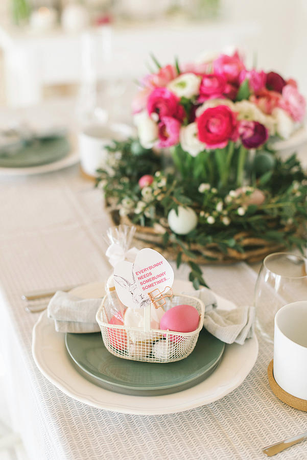 Place Setting Decorated With Easter Basket With Flower Arrangement In Background Photograph by Katja Heil