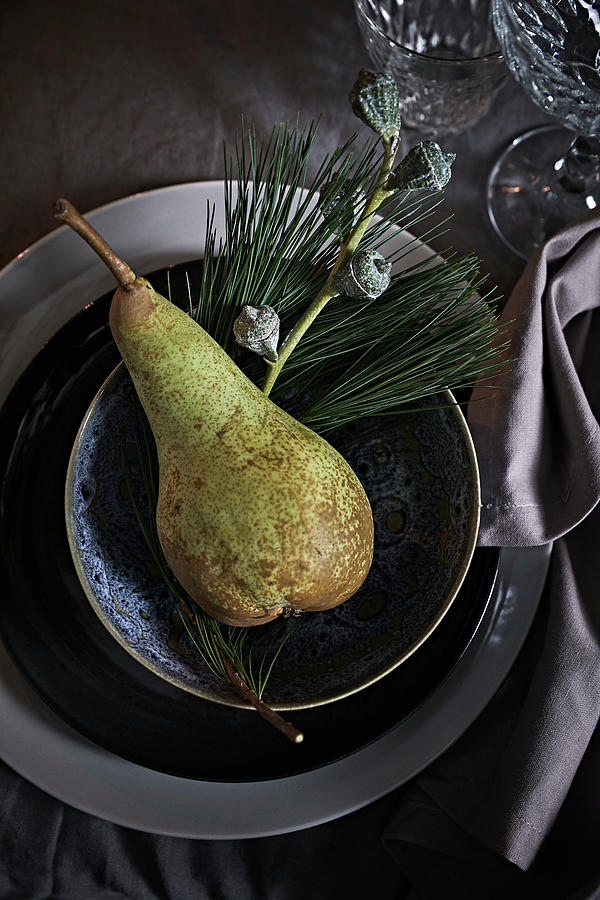 Place Setting Festively Decorated With Pear And Sprigs Of Eucalyptus And Pine Photograph by Nikky Maier