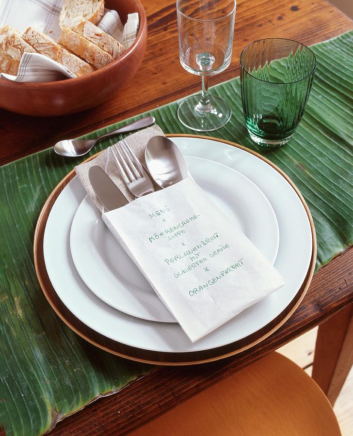 Place Setting On Banana Leaf With Menu Written In Paper Cutlery Bag Photograph by Veronika Stark