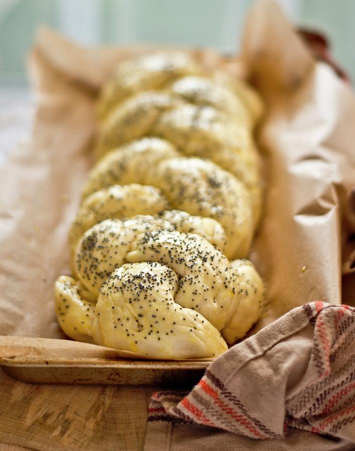 Plaited Bread With Poppy Seeds On A Piece Of Baking Paper Photograph by Dorota Indycka