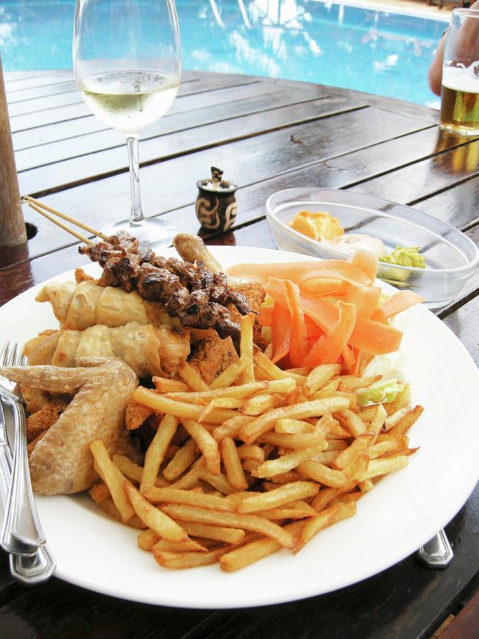 Plate Of Barbecued Food And Chips On Table By Swimming Pool Photograph by Koeb, Ulrike