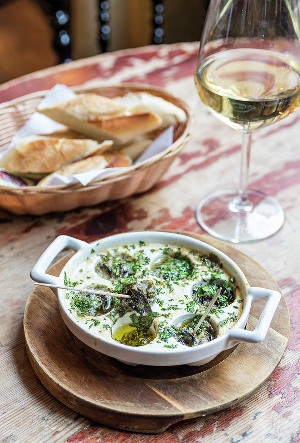 Plate Of French Escargot Snails In A Butter Sauce With Herbs With Bread And Wine In The Background Photograph by Giulia Verdinelli Photography