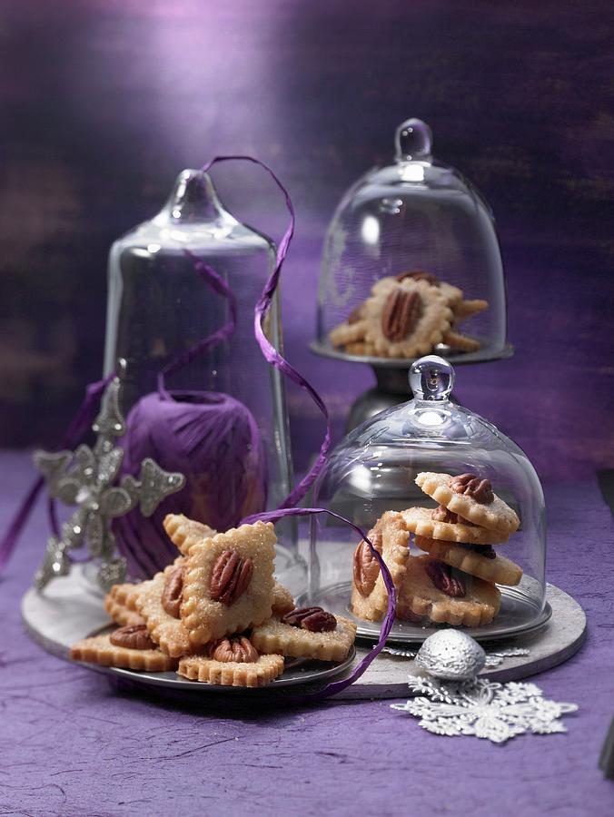 Plates Of Pecan Nut Biscuits Under Glass Cloches Photograph by Jalag / Jan-peter Westermann