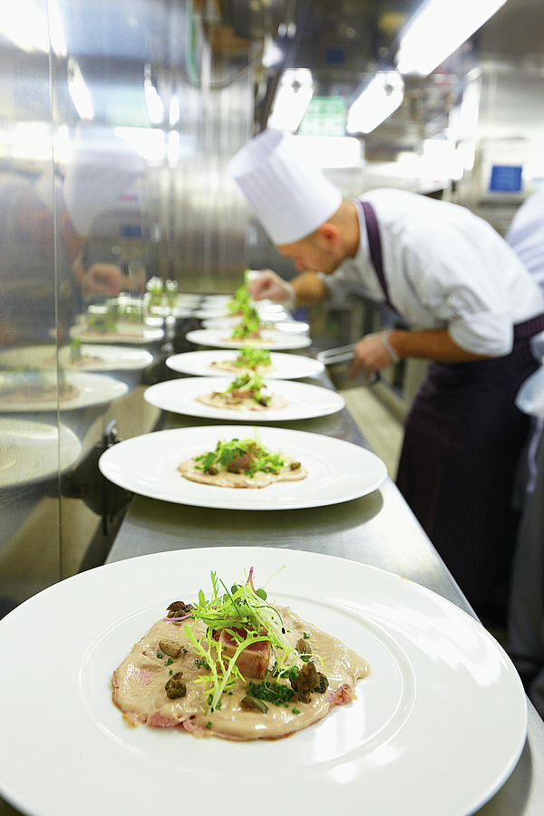 Plates With Dish In A Row In Kitchen On Cruise Ship, Europe Photograph by Jalag / Gtz Wrage