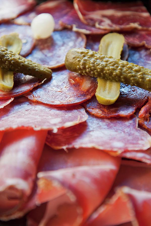 Platter Of Sliced Sausage With Pickled Gherkins italy Photograph by Anthony Lanneretonne