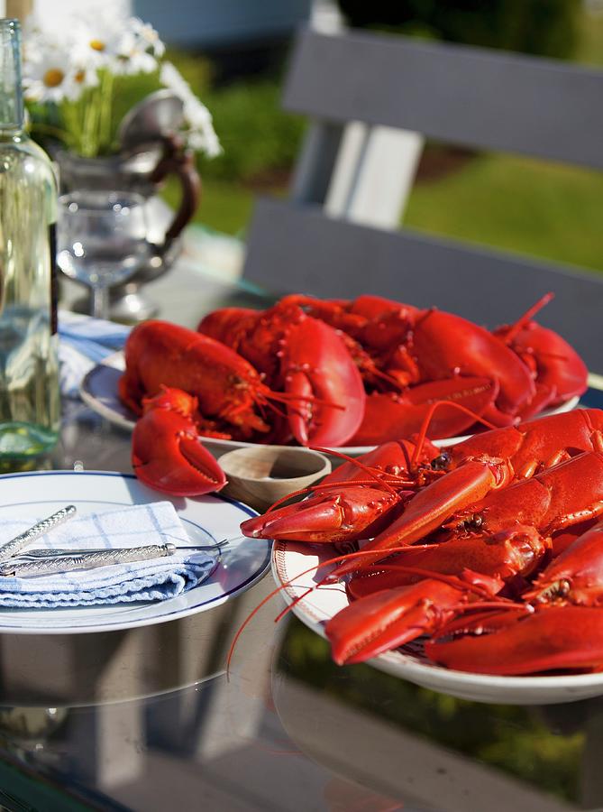 Platters Of Fresh Cooked Lobsters On An Outdoor Table Photograph by Strokin, Yelena