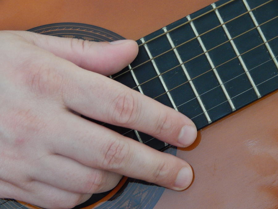 Music Photograph - Playing hands on guitar music by Oleg Prokopenko