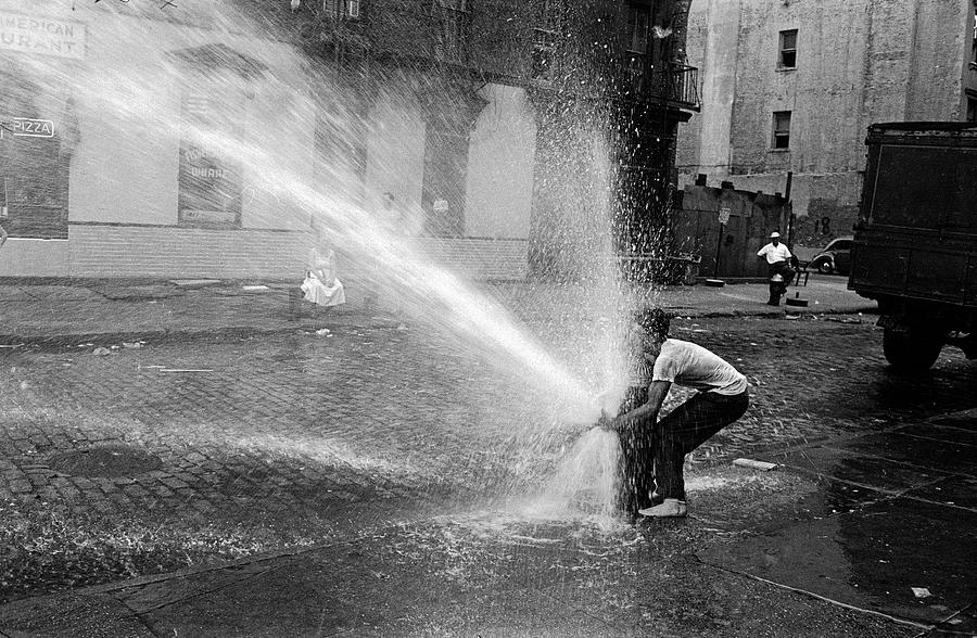 Black And White Photograph - Playing With A Fire Hydrant by Peter Stackpole