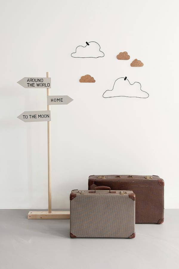Playroom Decorations; Suitcases, Signpost And Hand-crafted Clouds Made From Wire And Cardboard On Wall Photograph by James Stokes