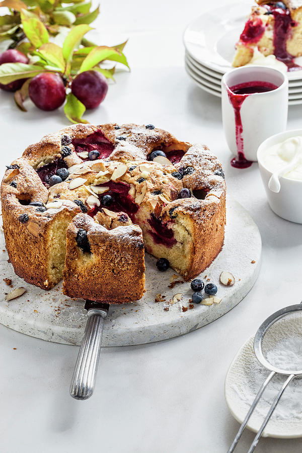 Plum And Blueberry Cake With Cream And Plum Sauce Photograph by The Food Union
