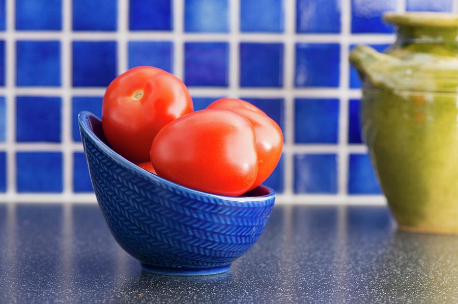 Plum Tomatoes In Bowl On Kitchen Counter Photograph by Lars Hallstrm