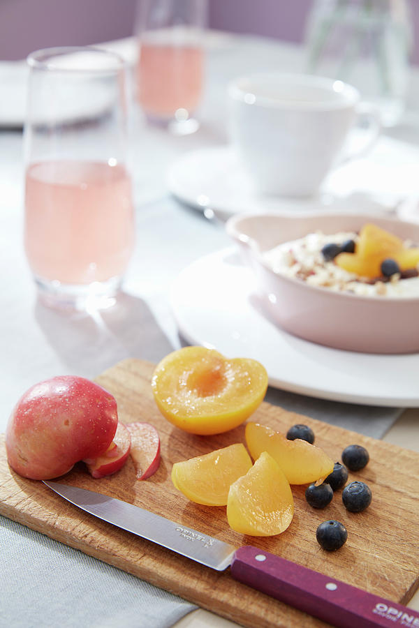 Plums And Blueberries On Wooden Board On Set Breakfast Table Photograph by Greenhaus Press
