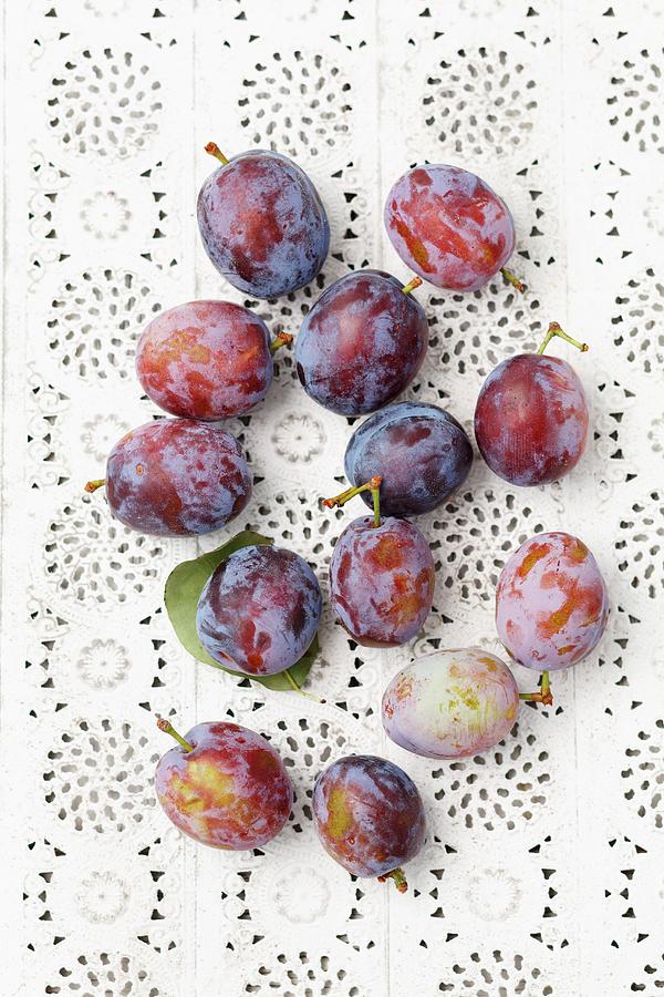 Plums On A Lace Surface Photograph by Rua Castilho