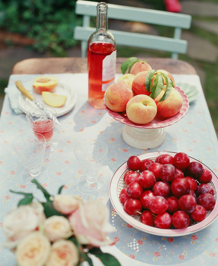 Plums, Peaches, Wine And Flowers On A Photograph by Victoria Pearson Plums, Peaches, Wine And Flowers On A Photograph by Victoria Pearson