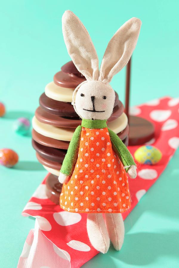 Plush Rabbit Toy In Front Of A Chocolate Easter Egg Photograph by Francine Reculez