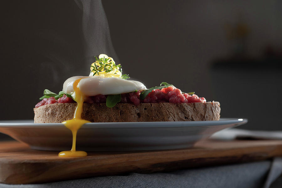 Poached Egg On Beef Tartare And Bread Photograph by Mmirkophoto