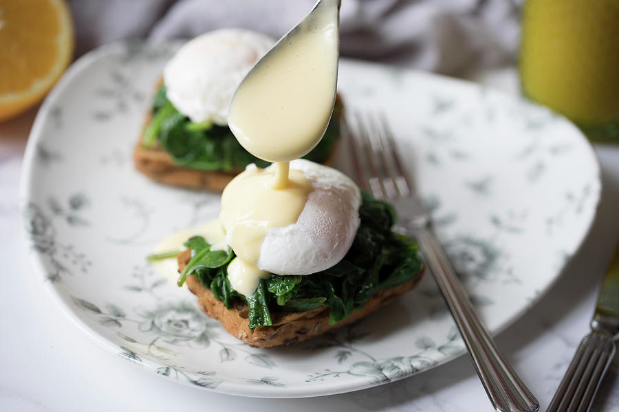 Poached Eggs On Toast With Spinach And Hollandaise Sauce Photograph by Joan Ransley