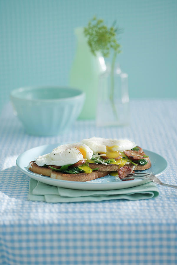 Poached Eggs With Sausage Spinach On Toast Photograph by Colin Cooke