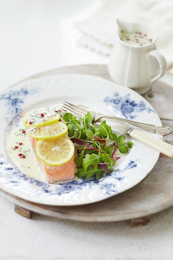 Poached Salmon Fillet With A Pink Pepper Sauce, Lemons And Salad Photograph by Charlotte Tolhurst