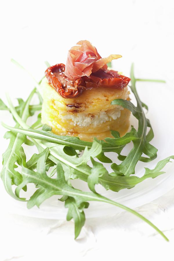 Polenta With Dried Tomatoes, Ham And Rocket Photograph by Hilde Mche
