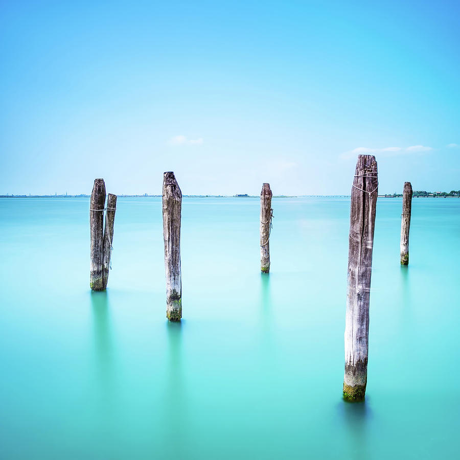 Poles and soft water on Venice lagoon. Long exposure. Photograph by Stefano Orazzini