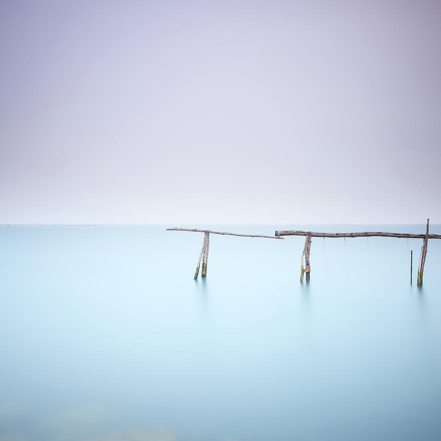 Poles and soft water on water landscape. Long exposure. Photograph by Stefano Orazzini